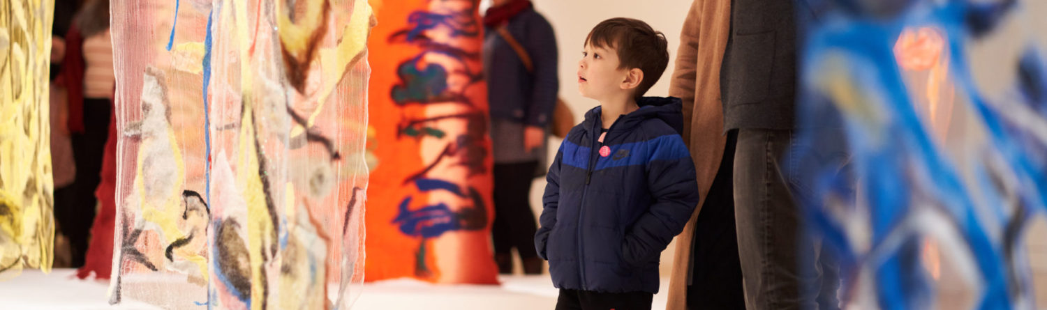 Boy looking at art installation