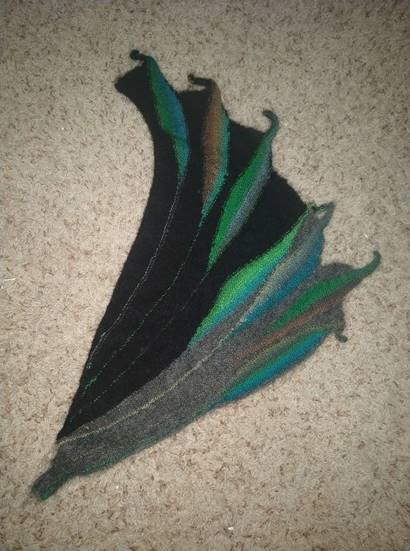 Horn shaped textile art in black, gray, blue, and green