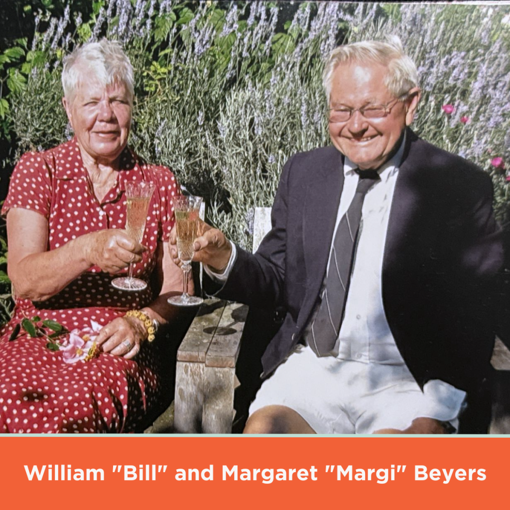 On a sunny day, late donors William "Bill" and Margaret "Margi" Beyers, a married, elderly white couple, drink in front of a bush of lavender.