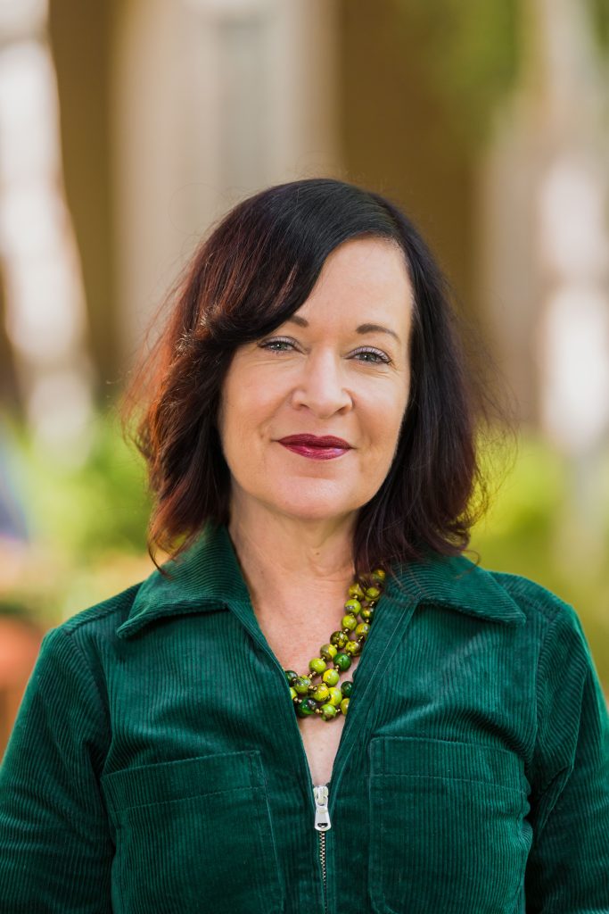 ArtsFund is pleased to introduce Deborah Cullinan as our keynote speaker for the 2025 Celebration of the Arts Event on September 11 at McCall Hall in Seattle Center. She's a middle-aged white woman with brown hair and green eyes. She's wearing a dark green shirt and a green and yellow necklace.