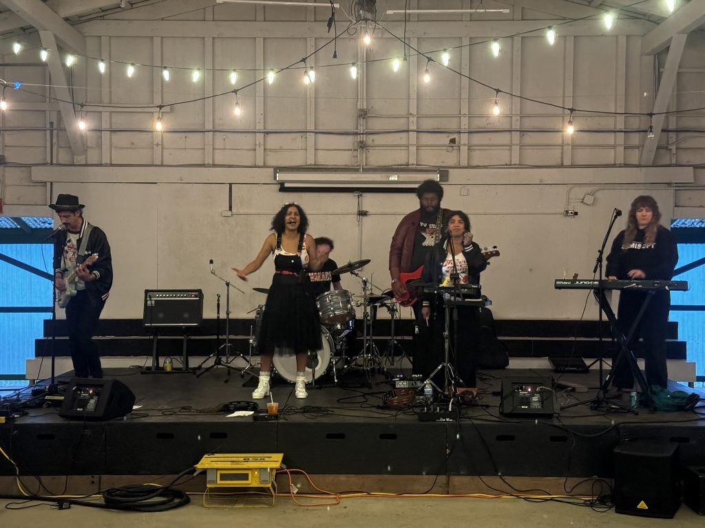 A band performs on a stage under twinkling lights.